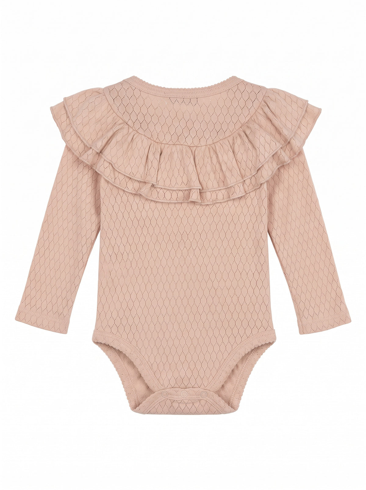 Girl wearing a soft ribbed cotton piece with ruffled shoulders and neckline, long fitted sleeves, and hidden snap closures.