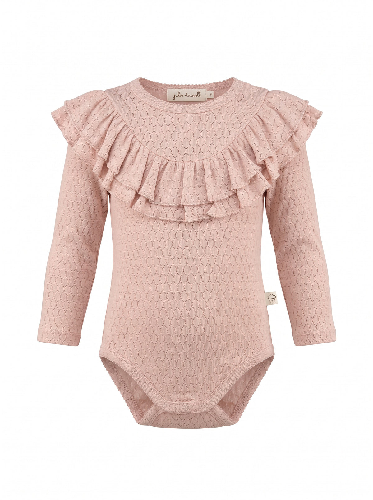 Girl wearing a soft ribbed cotton piece with ruffled shoulders and neckline, long fitted sleeves, and hidden snap closures.